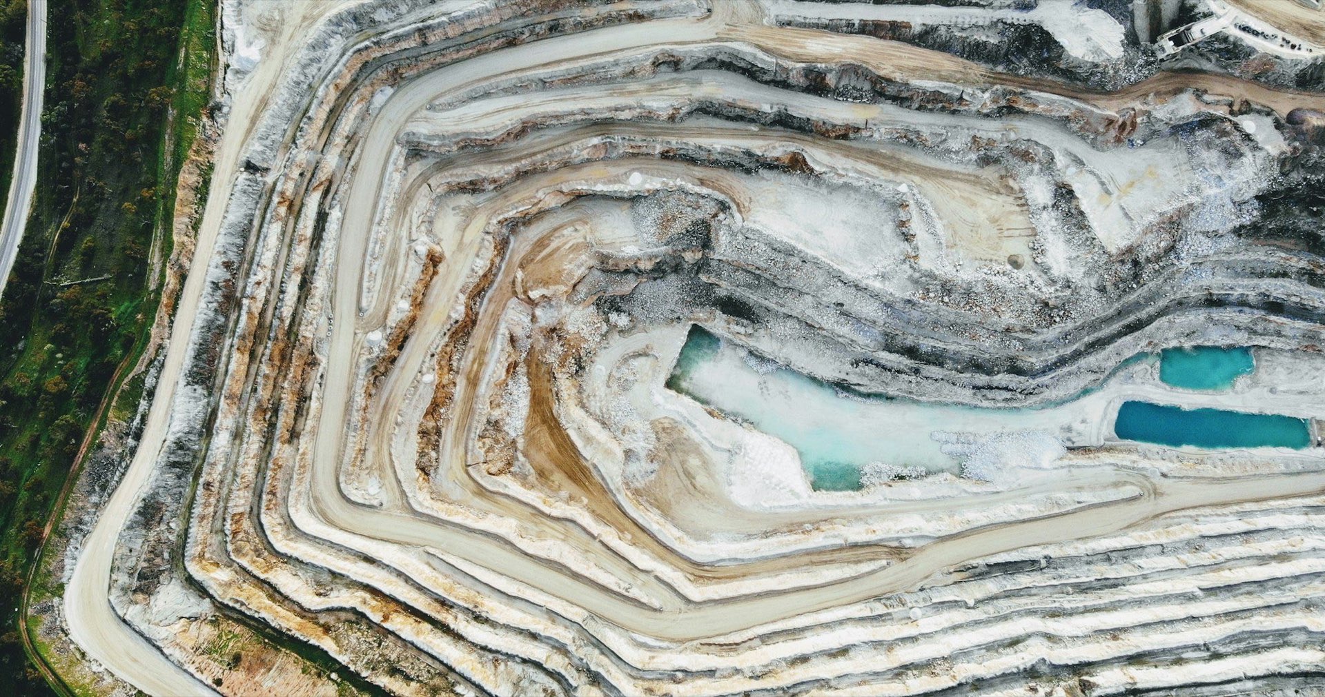 Aerial view of the terraced benches of an open-pit mine