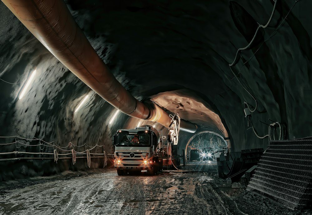 Vehicle working inside a lit underground tunnel